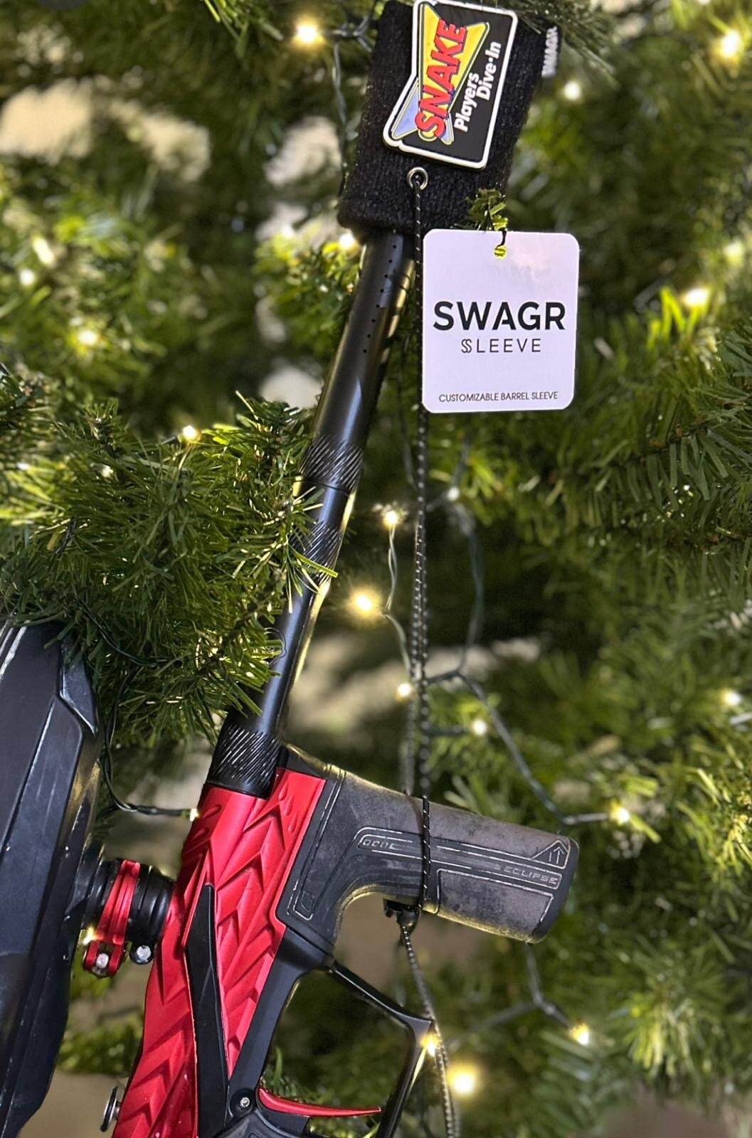 SWAGR Sleeve customizable barrel cover with a Snake Dive-In patch and hangtag shown on a paintball marker