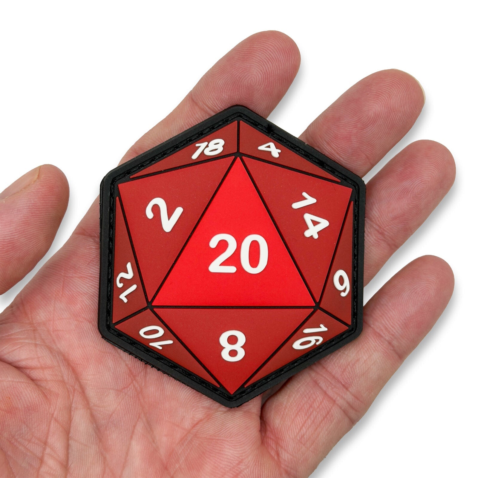 Glow in the dark D20 patch held in hand for scale by Patch Fiend
