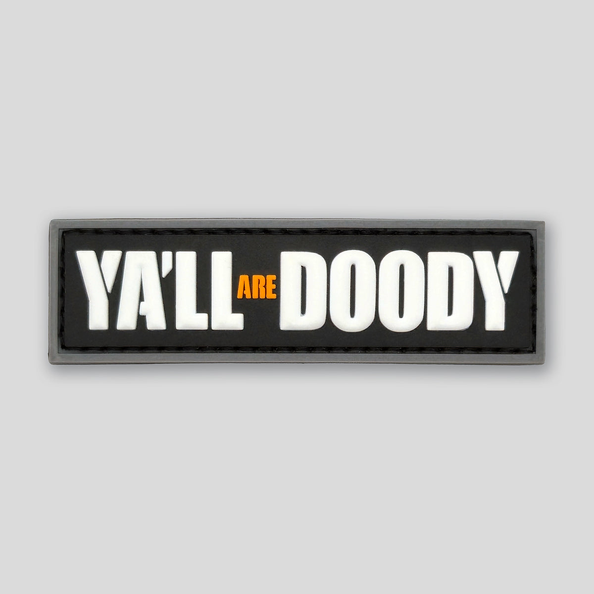 Rectangular patch with 'YA'LL ARE DOODY' text on a black background
