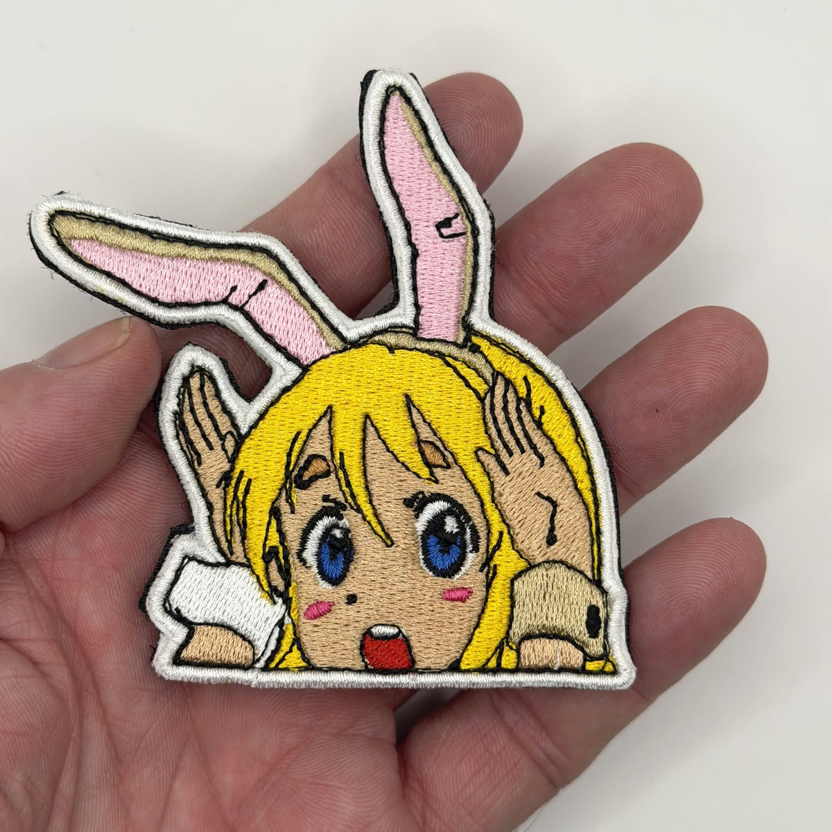 Tea Time Bunny peeker embroidered patch held in hand for size, by FOTB Patches