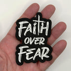 Faith Over Fear embroidered patch held in hand for size, by FOTB Patches