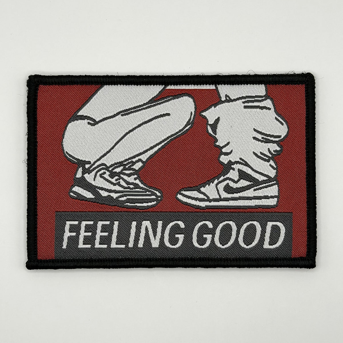 Feeling Good woven patch, two pairs of sneakers with one crouched in front of the other, by FOTB Patches