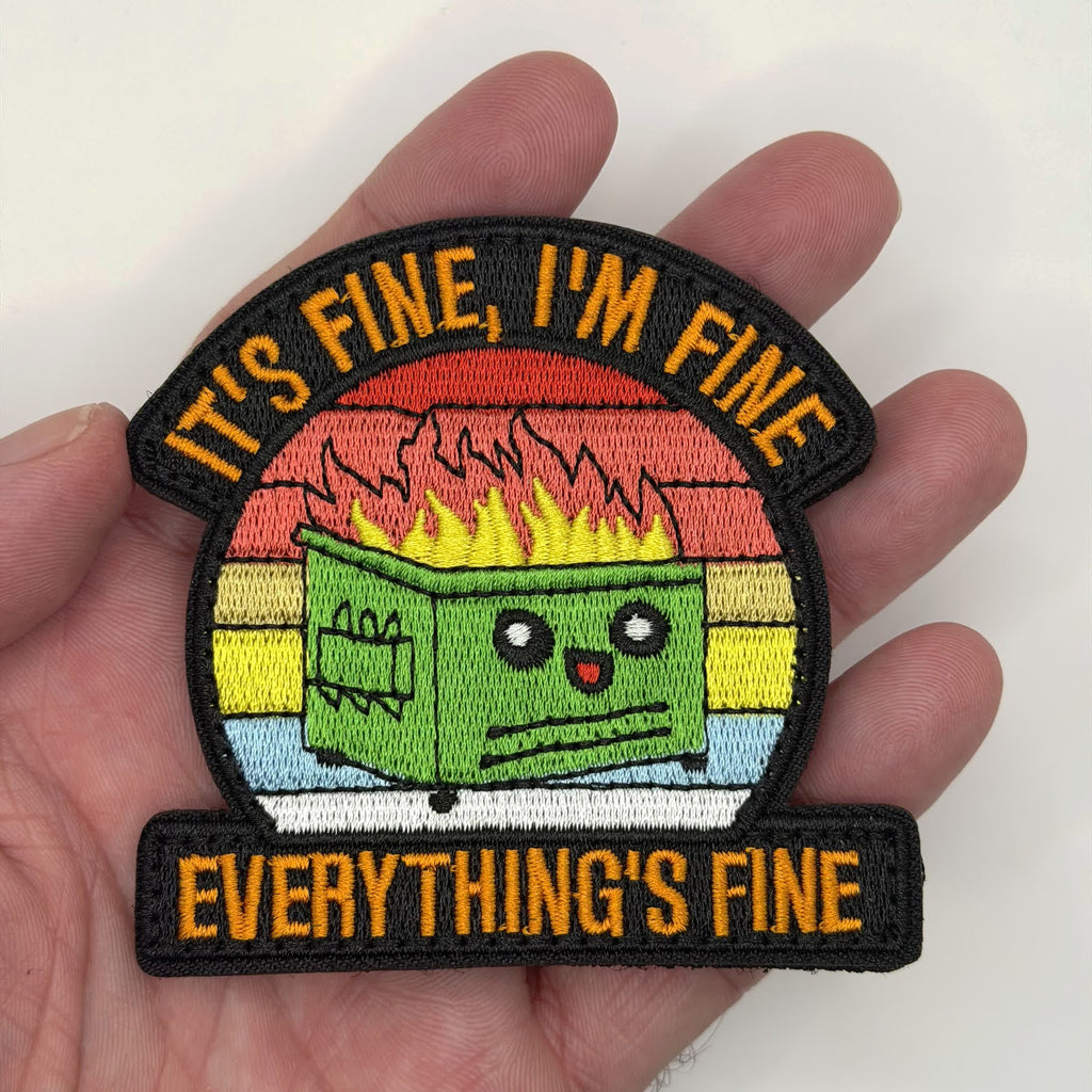 It's Fine dumpster fire embroidered patch held in hand for size, by FOTB Patches