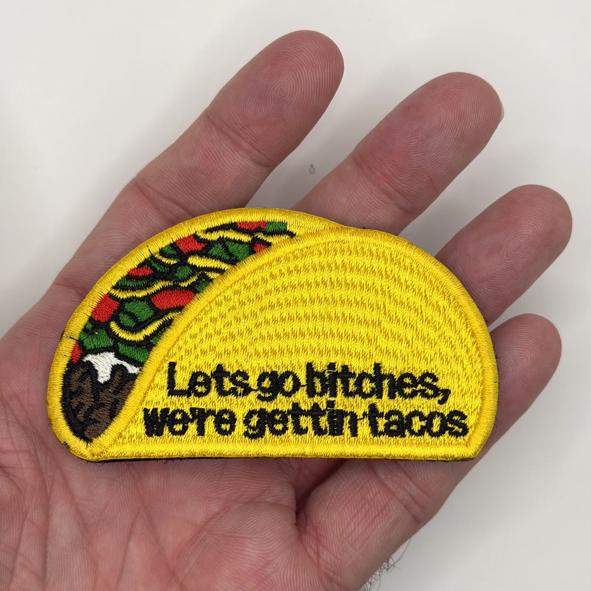 Gettin' Tacos embroidered patch held in hand for size, by FOTB Patches
