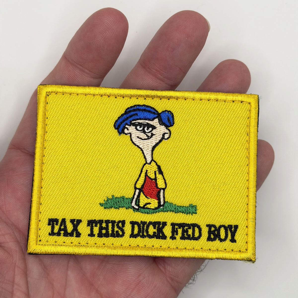 Tax This Fed Boy embroidered patch held in hand for size, by FOTB Patches