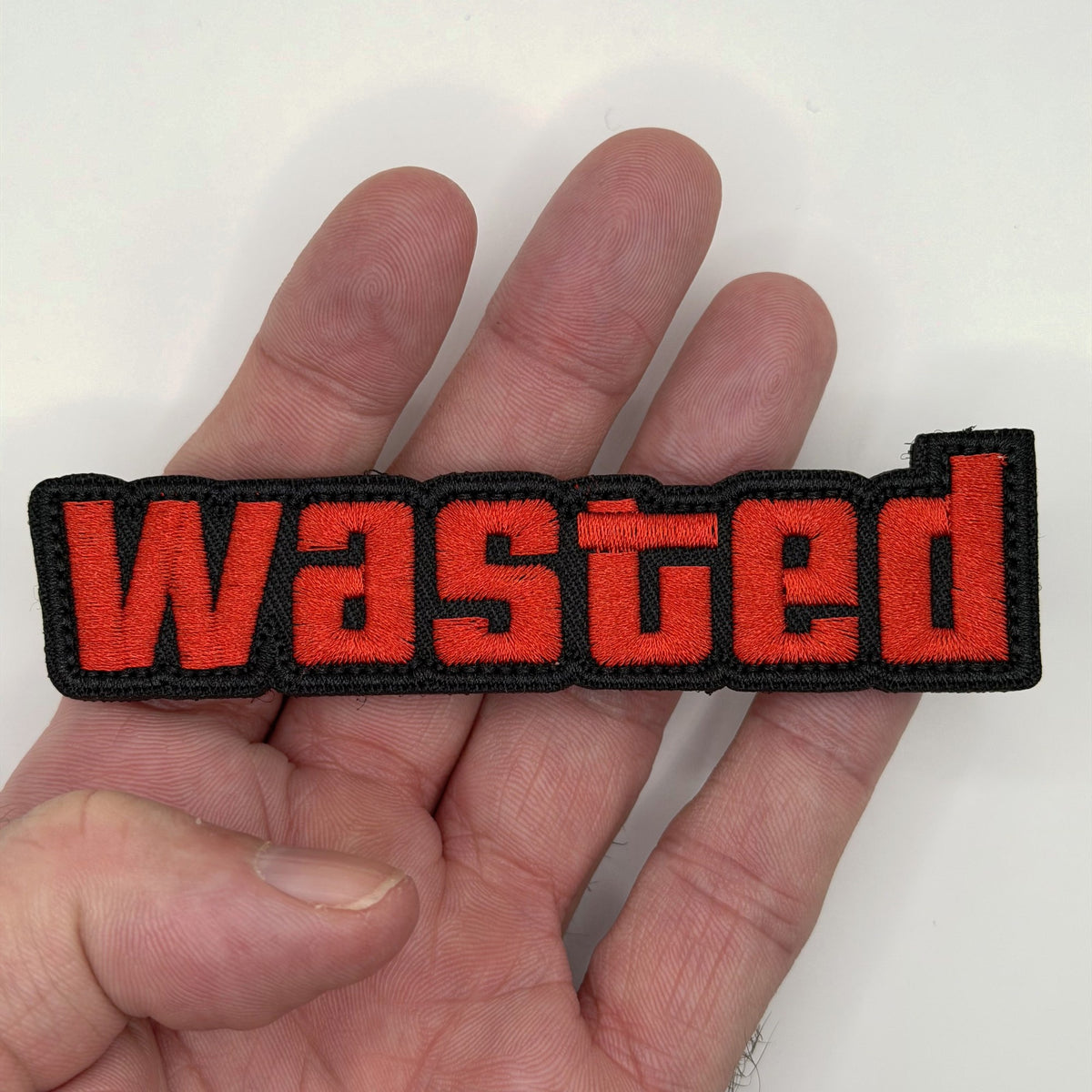 Wasted embroidered patch held in hand for size, by FOTB Patches