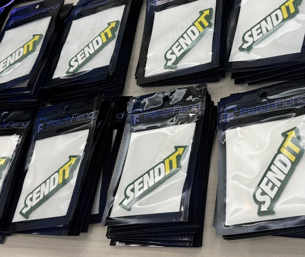 Stacks of bagged Send It patches ready to ship